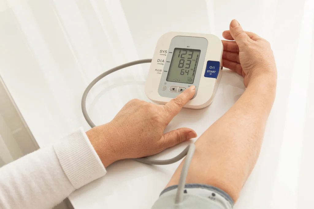 A woman checking her blood pressure at home