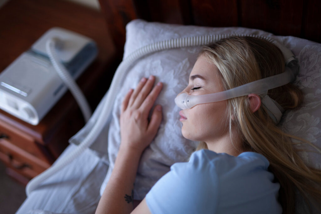 A woman sleeping with a CPAP machine in El Paso.