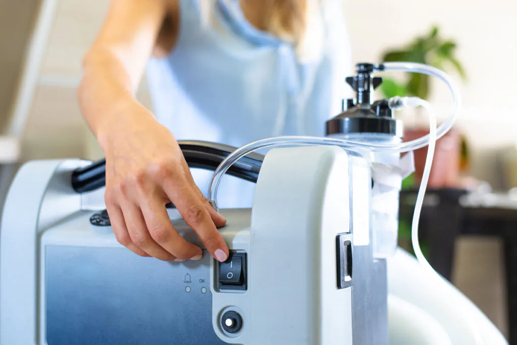A person turning on a piece of home medical equipment from a medical supply store in El Paso.